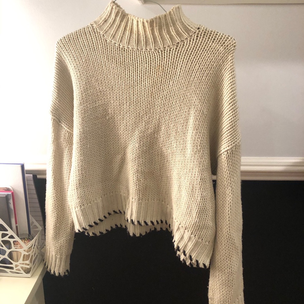 Cream Turtleneck w black stitching on the bottom